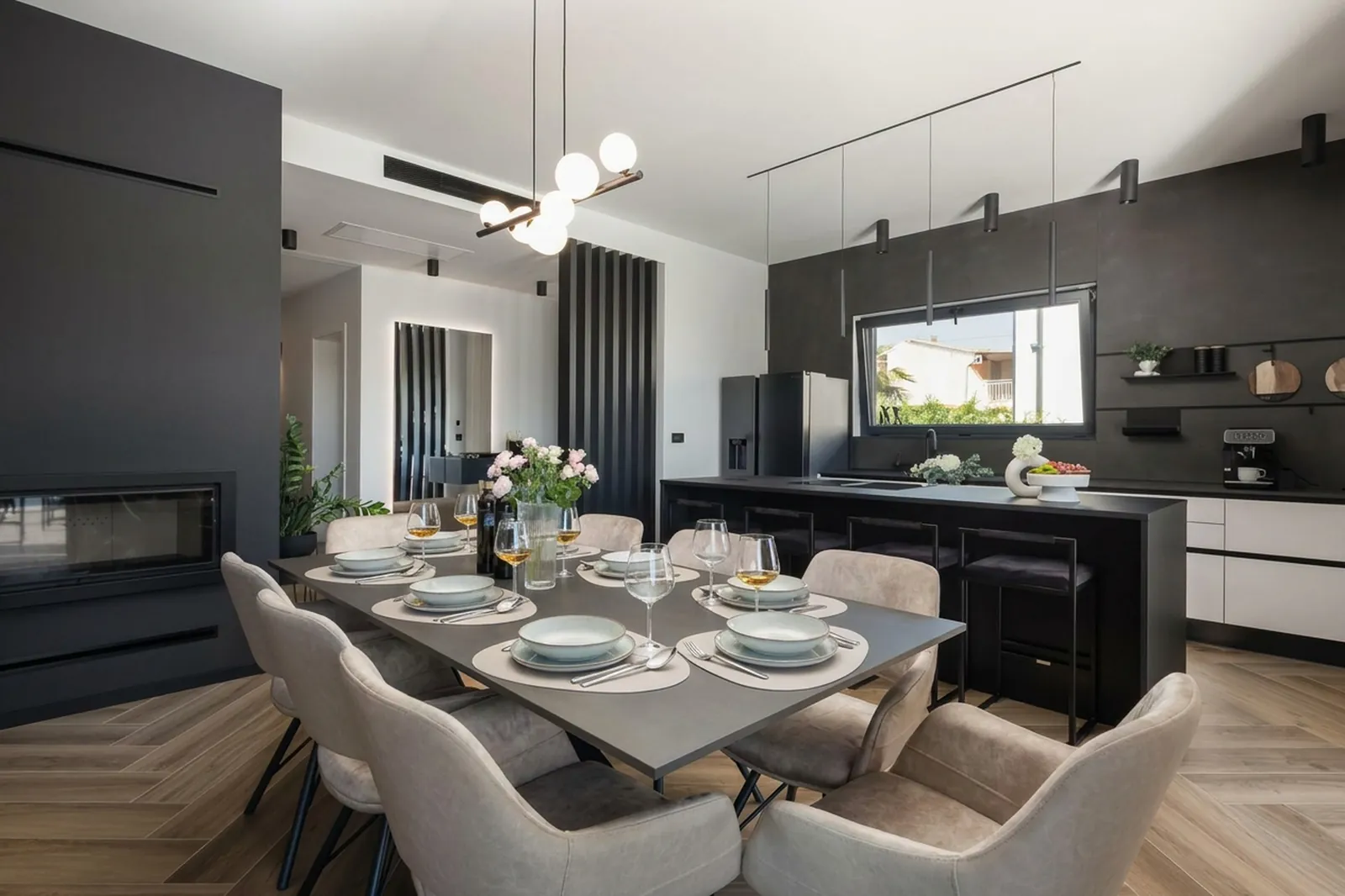 Dining table set for a meal beside the kitchen