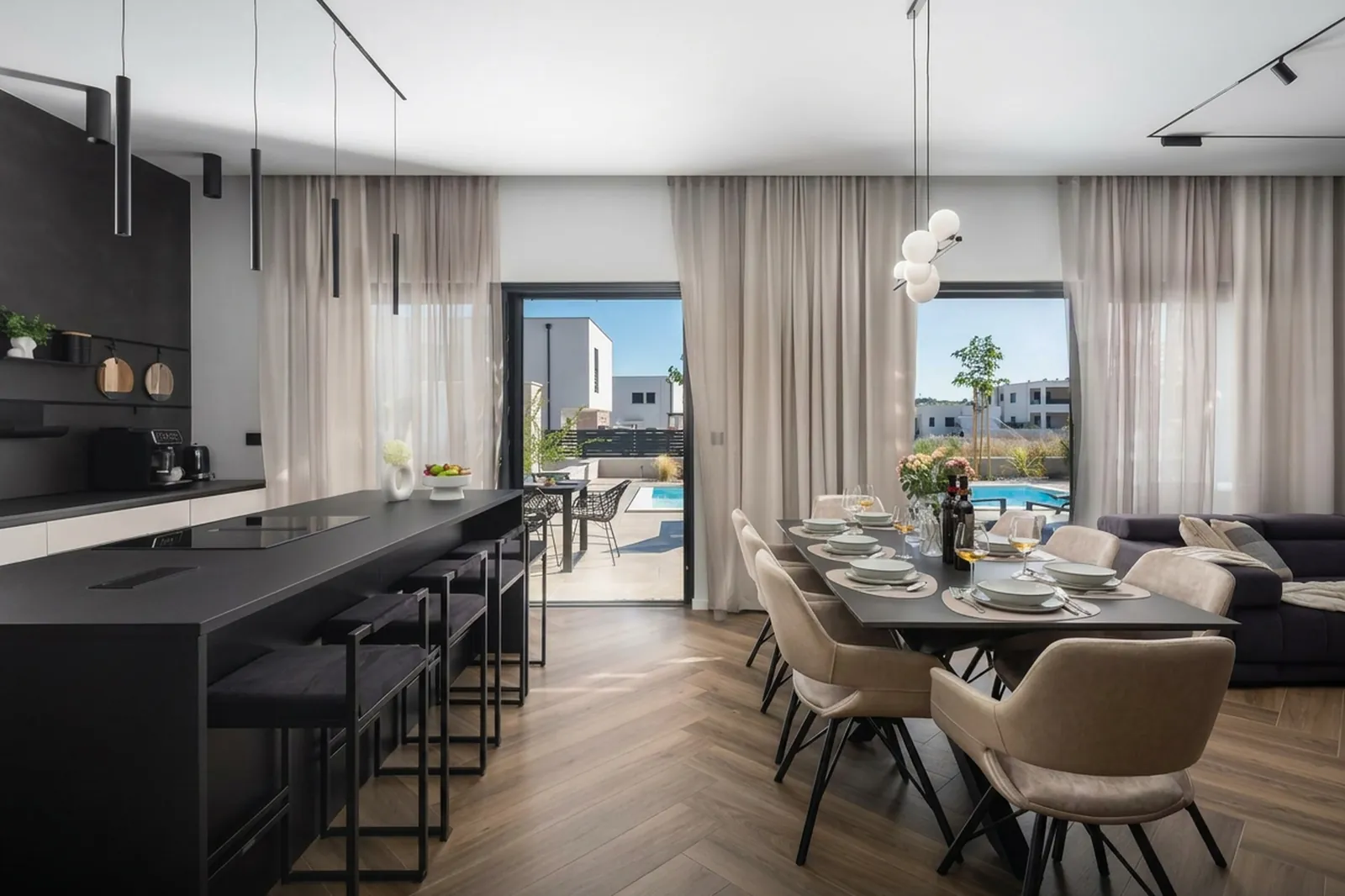 Open kitchen with a long island looking through to the pool