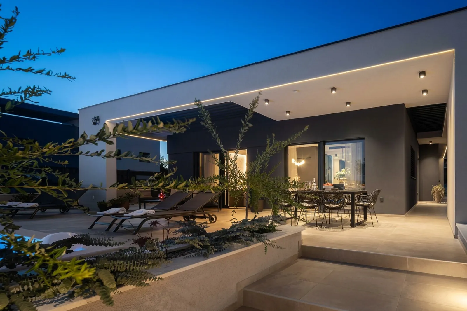 Evening terrace and outdoor lounge under a deep blue sky