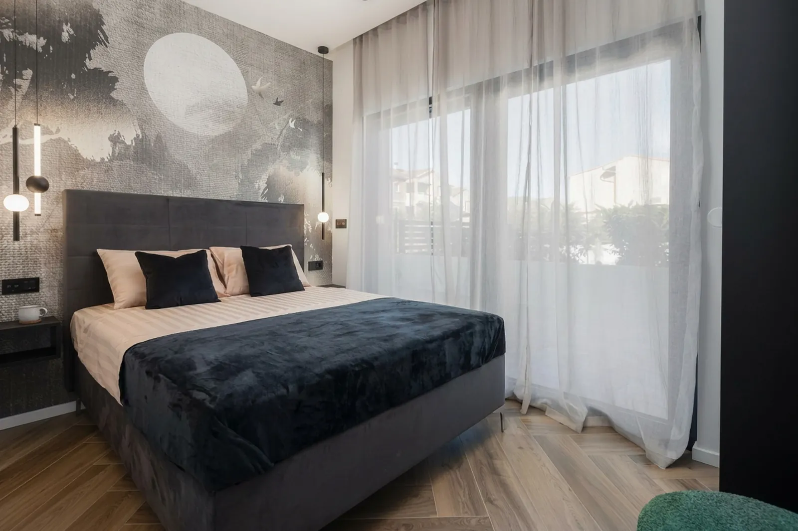 Third suite with a dark bed and textured mural wall