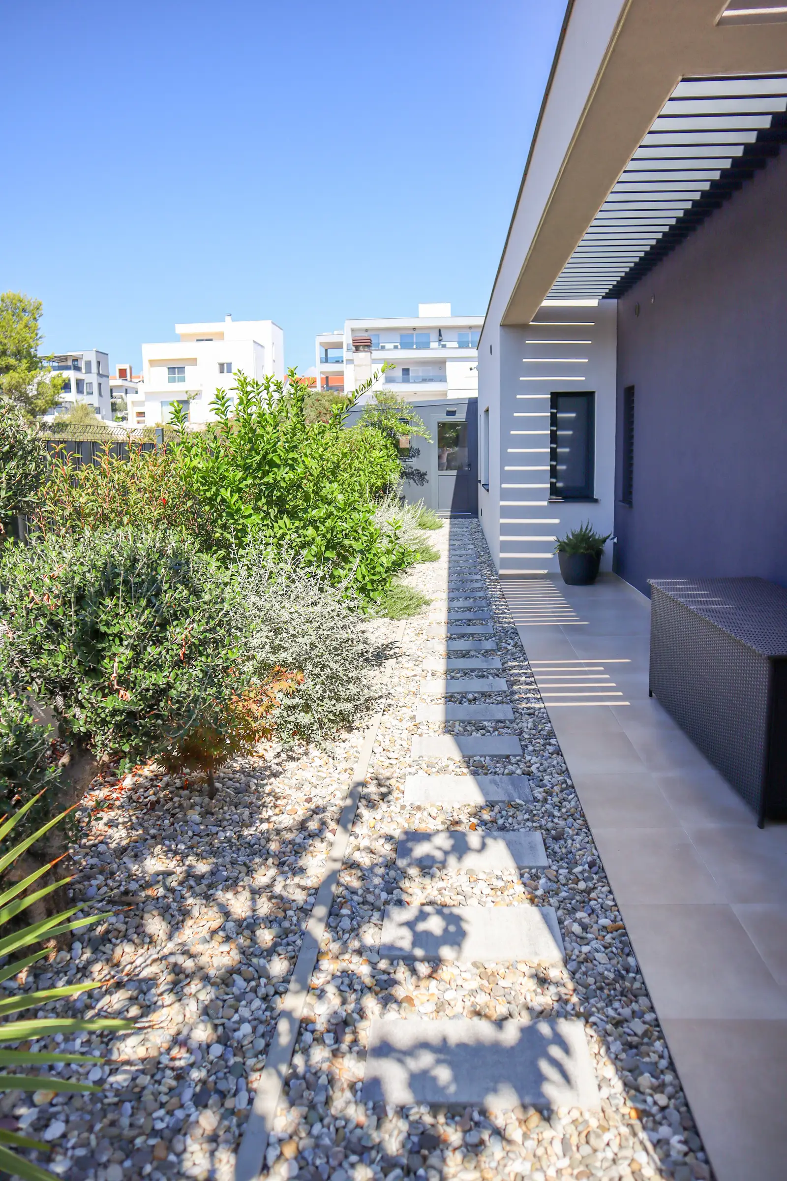 Side garden and path leading to the grill area